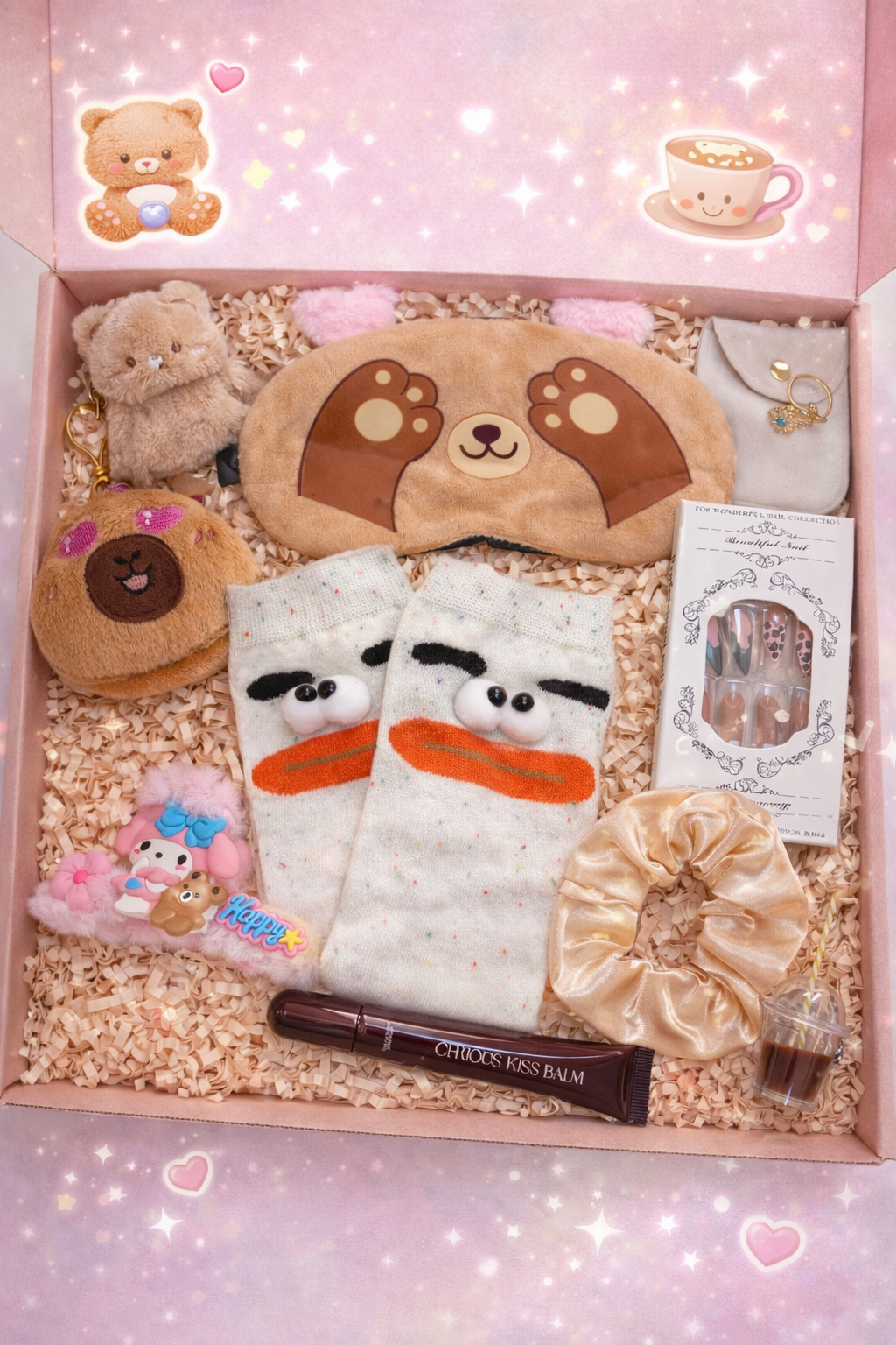 Gift box with plush toys, a sleep mask, and other items on a pink background